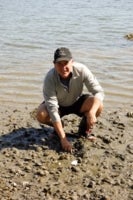 Steve Russell on the ocean's shore during a beach cleanup event